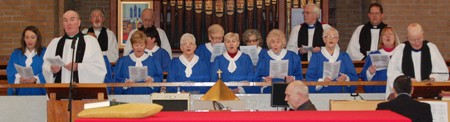 Choir and clergy sing at the service in Kilmakee.